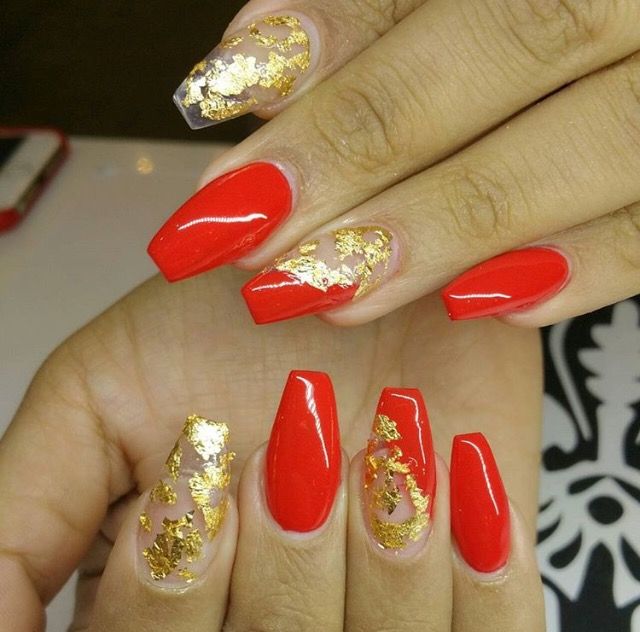 Bold Red Nails with Elegant Gold Flakes: A Glamorous Design for Any Occasion.