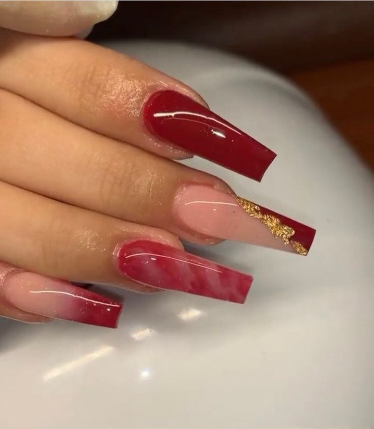 Sophisticated Ombre Nail Design with Deep Red, Soft Pink, and Gold Accents