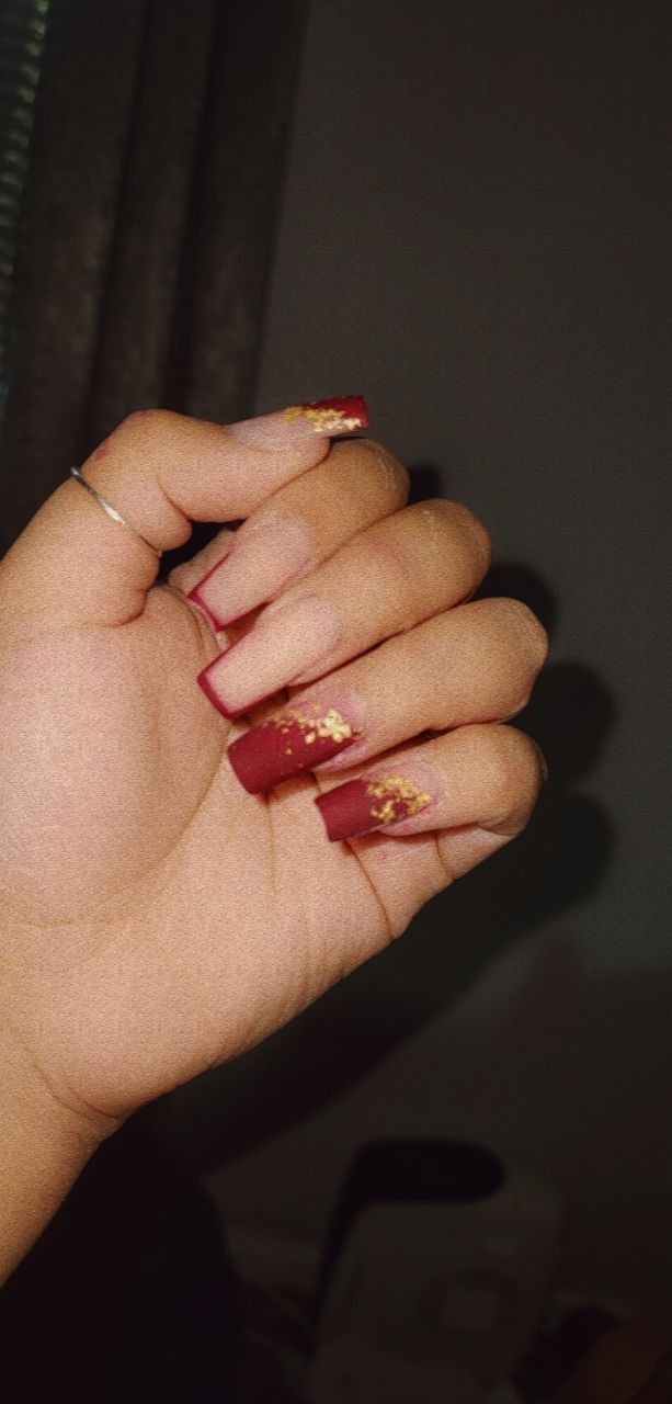 Sophisticated Burgundy Nails with Shimmering Gold Accents for Glamourous Occasions.