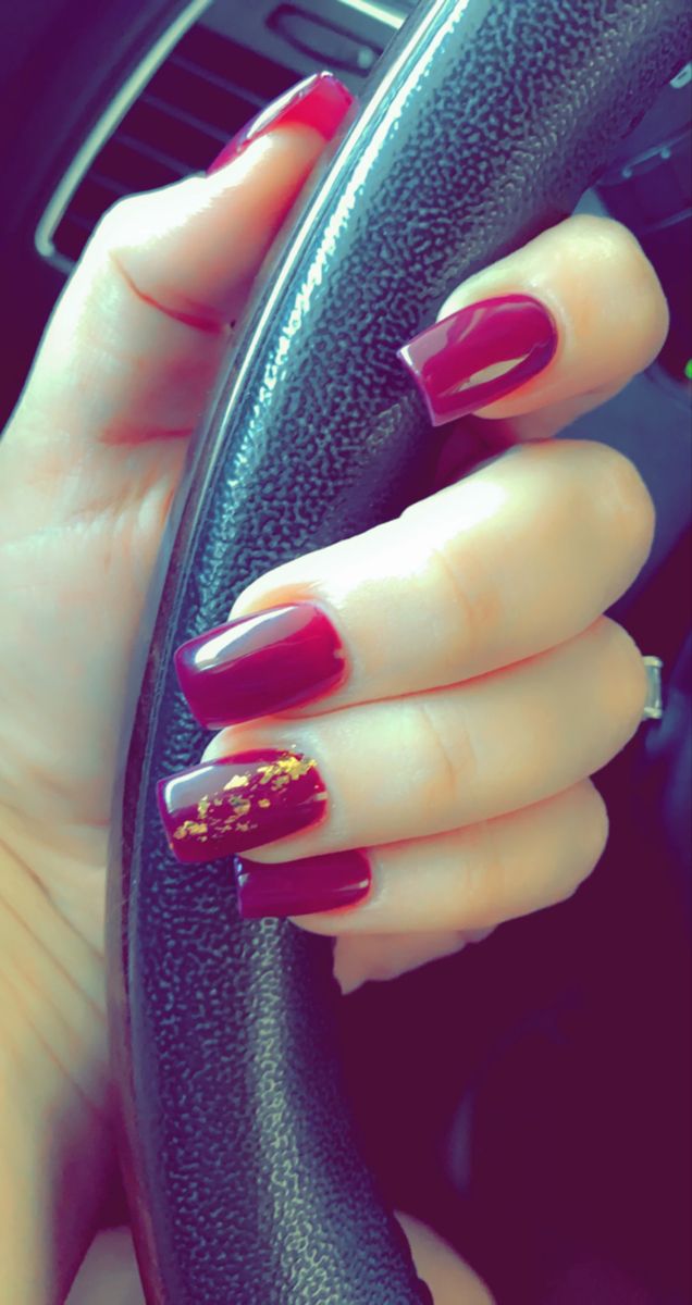 Chic Burgundy Nails with Glossy Finish and Glamorous Gold Glitter Accent.