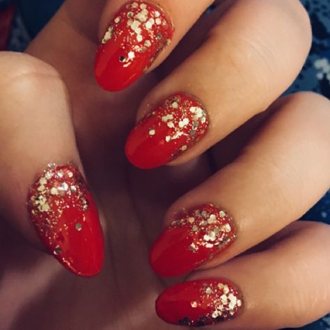 Festive Elegance: Glossy Red Nail Design with Golden Glitter Gradient.