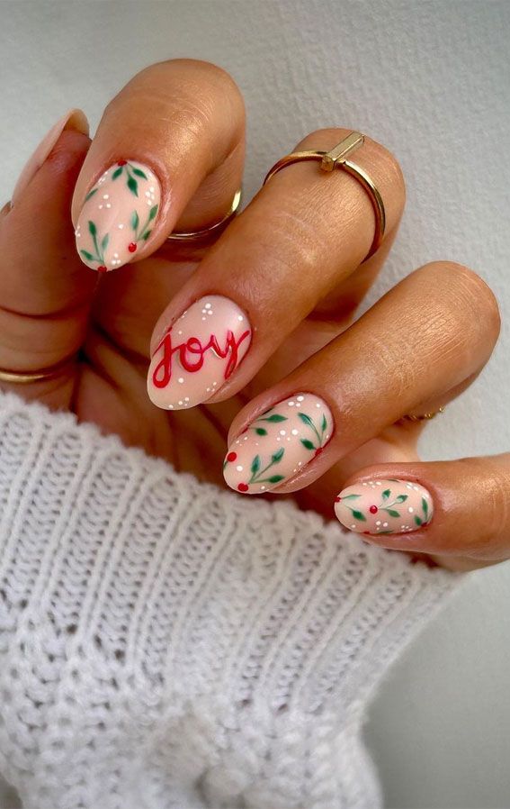 Charming Festive Nail Design with Soft Pink Base, Green Leaves, and Cheerful Red Accents