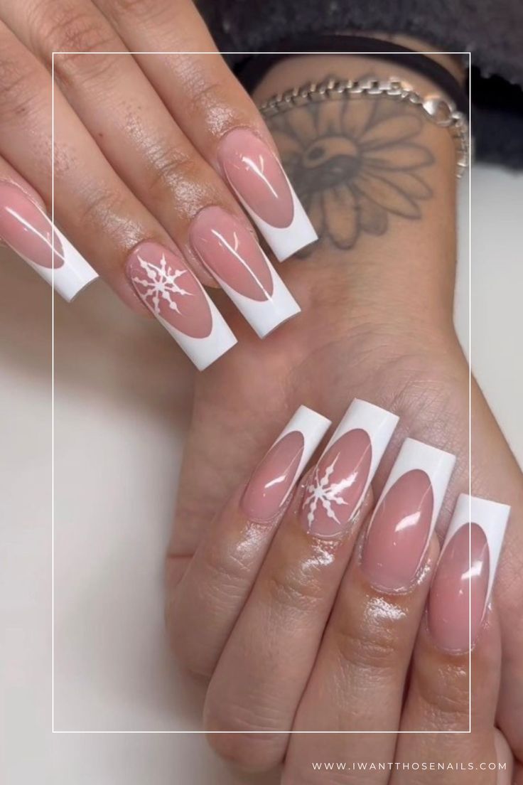 Chic Winter Nail Design: Classic French Tips with Contemporary Snowflake Patterns.