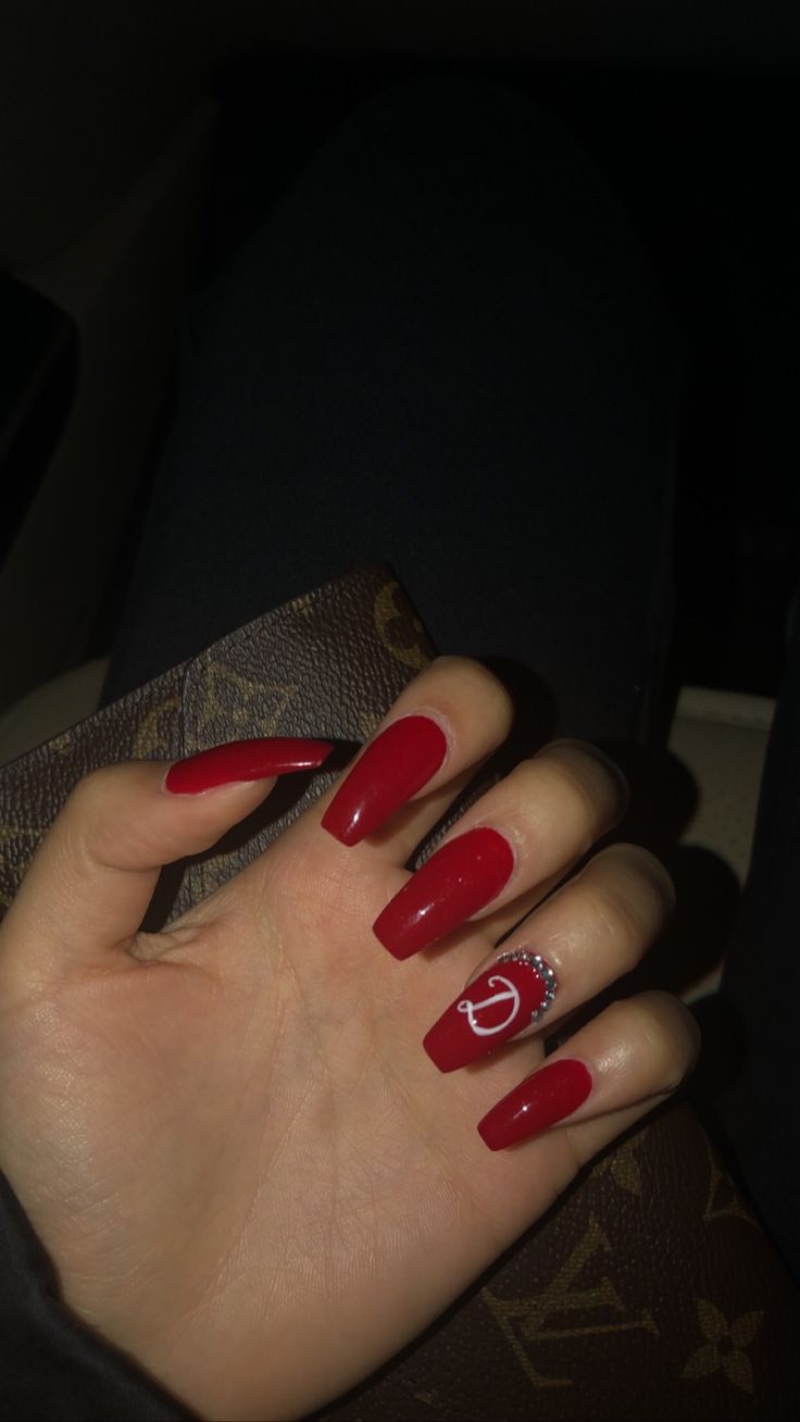 Sophisticated Elegant Red Acrylic Nails with Rhinestone Accent for a Confident Look.