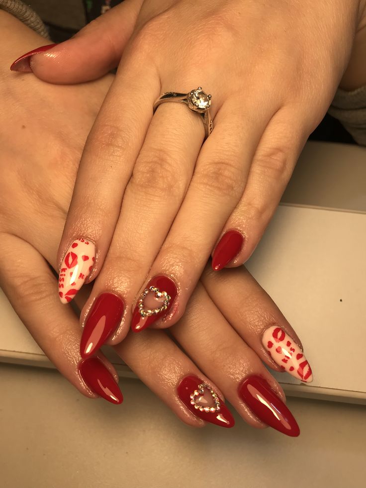 Sophisticated Almond-Shaped Red Manicure with Glossy and Patterned Designs, Gem Accents.