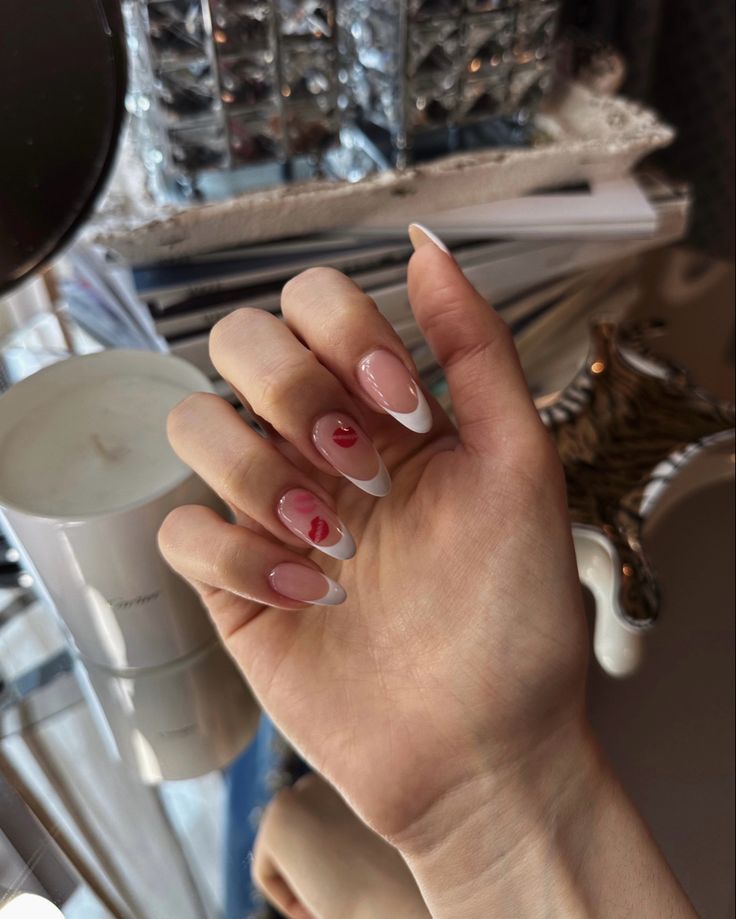 Sophisticated Nail Design: Translucent Pink and White Tips with Playful Red Heart Accent.