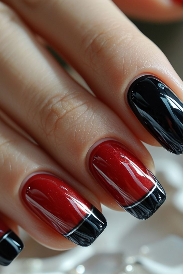 Sophisticated Nail Design: Striking Deep Red Base with Glossy Black French Tips.