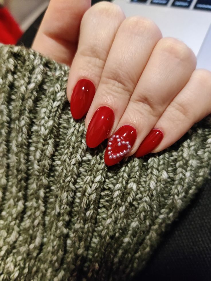 Elegant Red Nails with Pearls and Glossy Finish for a Romantic, Playful Look.