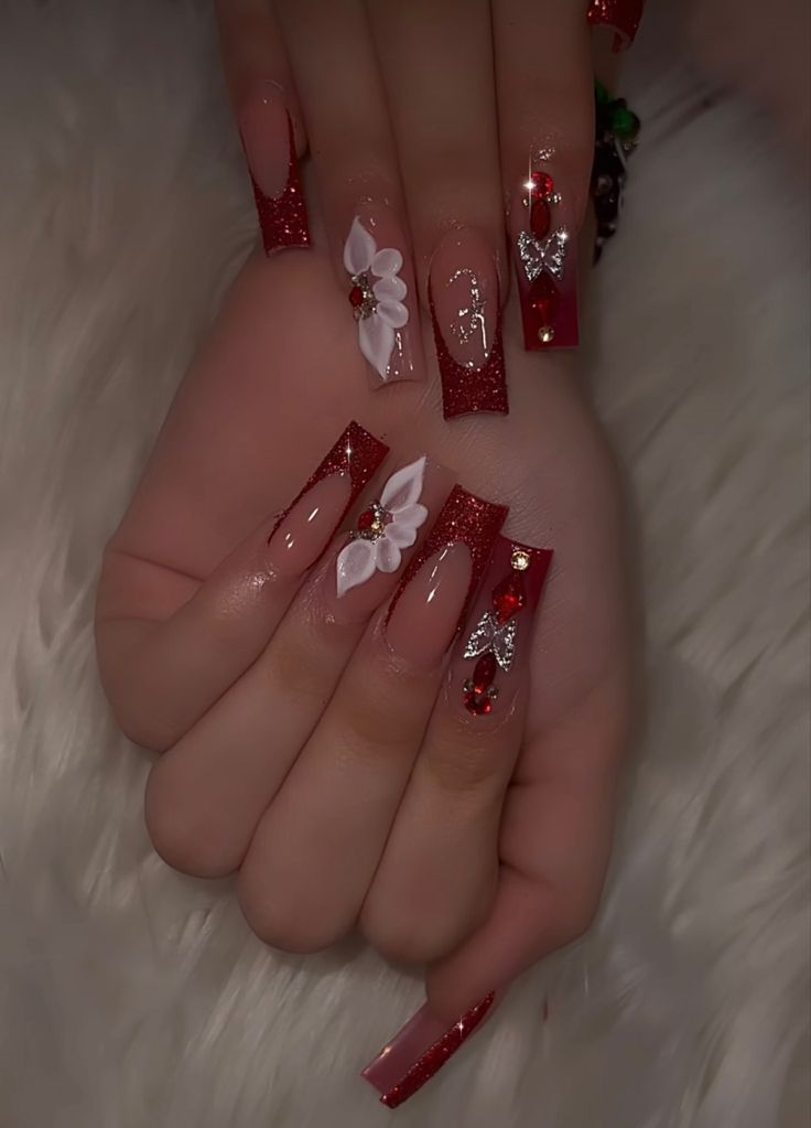 Festive Glamour: Dazzling Red Glitter Nails with Elegant Floral Designs.