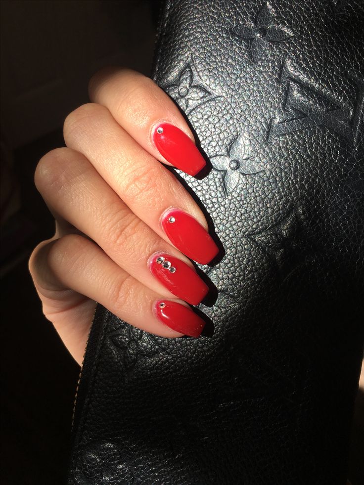 Chic Red Glossy Nails with Rhinestone Accents for Elegant Versatility.