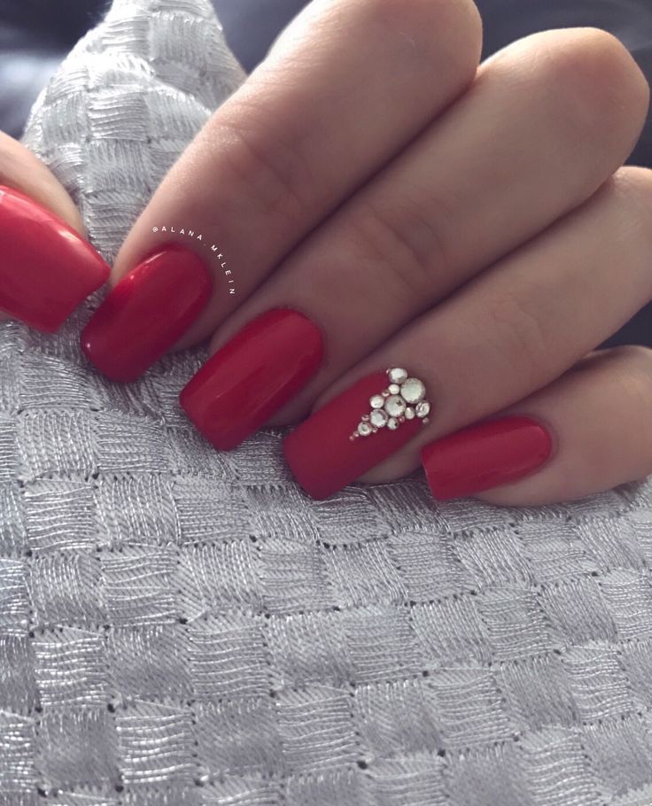 Elegant Glossy Red Manicure with Rhinestone Accent for Any Occasion