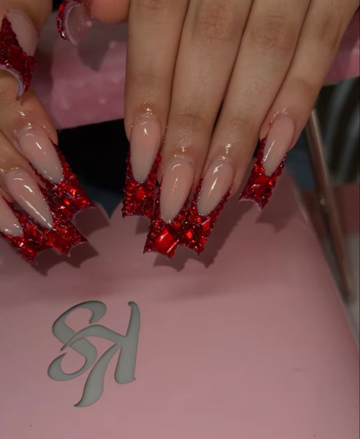 Elegant Long Nude Nails with Bold Red 3D Geometric Accents.