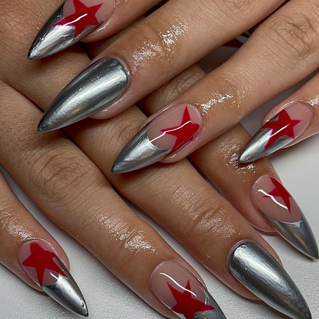 Bold Stiletto Nail Design: Sleek Metallic Silver with Vibrant Red Star Accents.