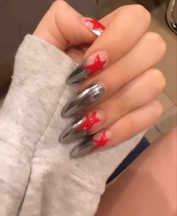 Bold and Artistic Metallic Silver and Red Star Nail Design.