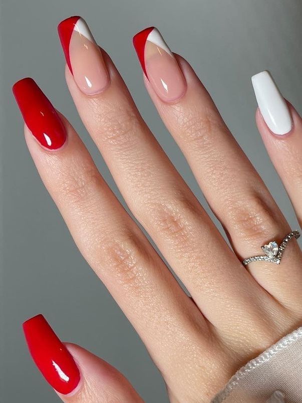 Elegant Asymmetrical French Tip Nail Design in Bold Red, White, and Nude Palette.