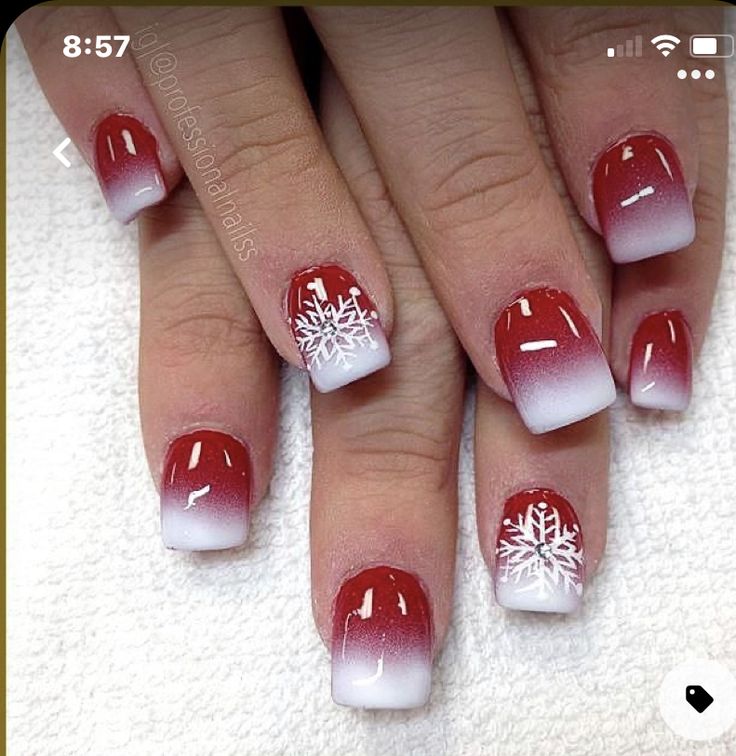 Festive Red and White Ombre Nail Design with Intricate Snowflake Accents for Holiday Elegance.