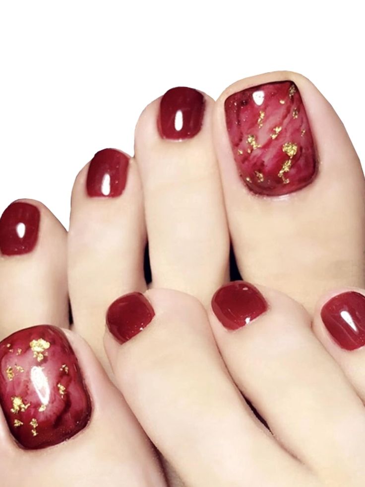 Sophisticated Burgundy Nail Design with Golden Accents and Marbled Patterns.