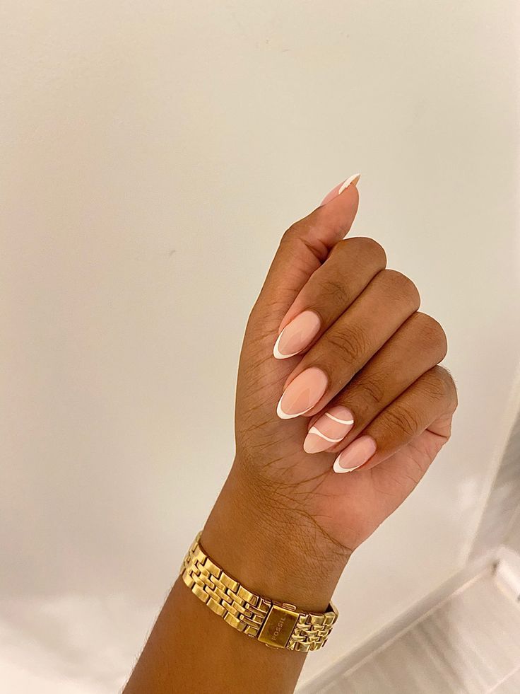 Sophisticated Almond-Shaped Manicure: Soft Nude Base with Contrasting White Tips.