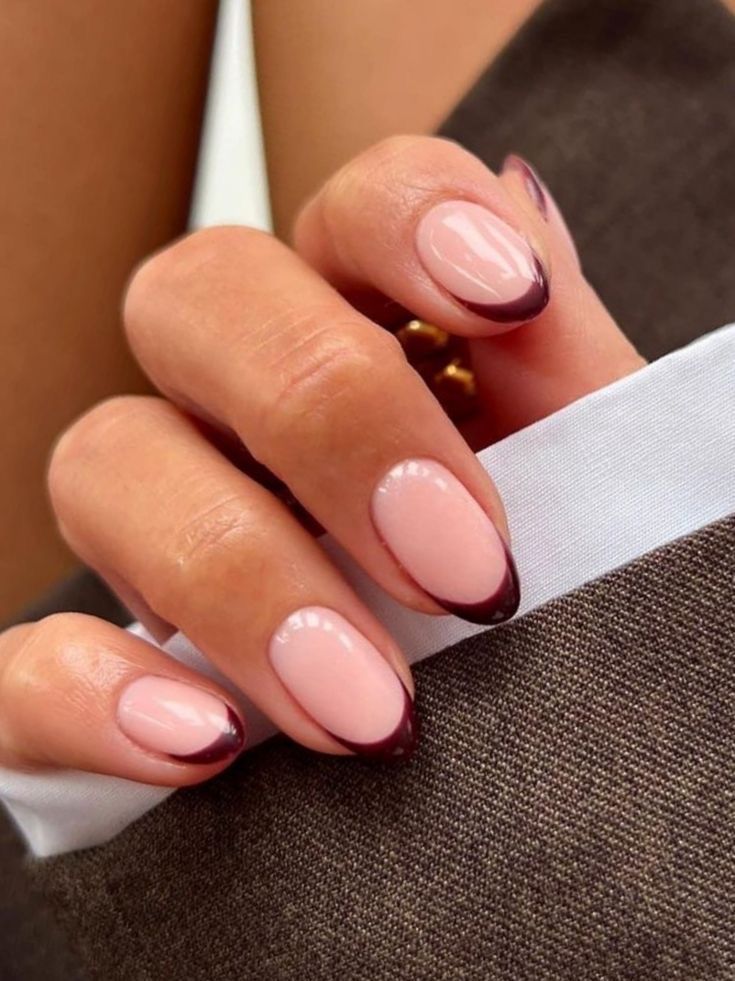 Chic Nail Design: Soft Nude Base with Dark Burgundy French Tips for Elegant Versatility.