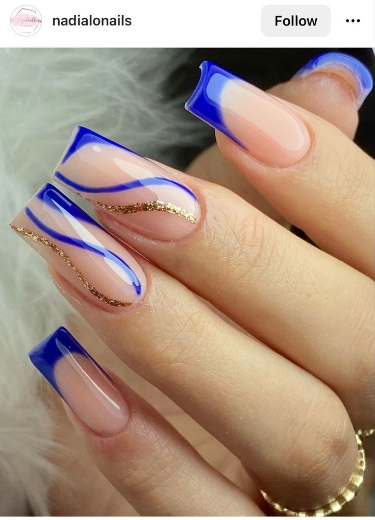 Chic and Sophisticated Nude and Blue Nail Design with Glossy Finish and Gold Accents.