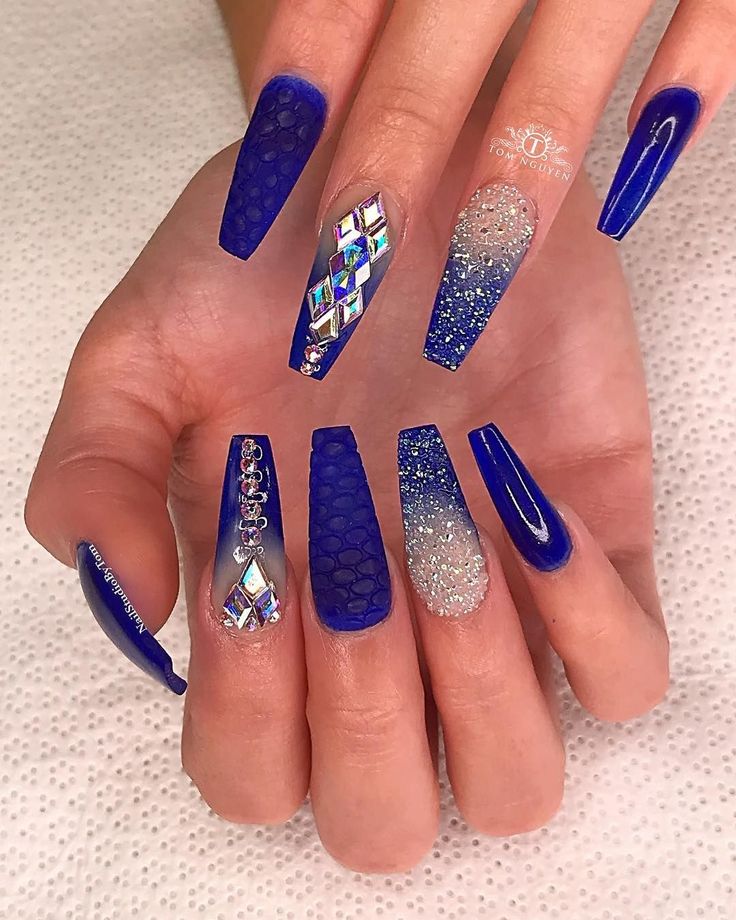 Bold Blue Nail Design: Glossy and Textured Finishes Enhanced by Geometric and Glitter Accents