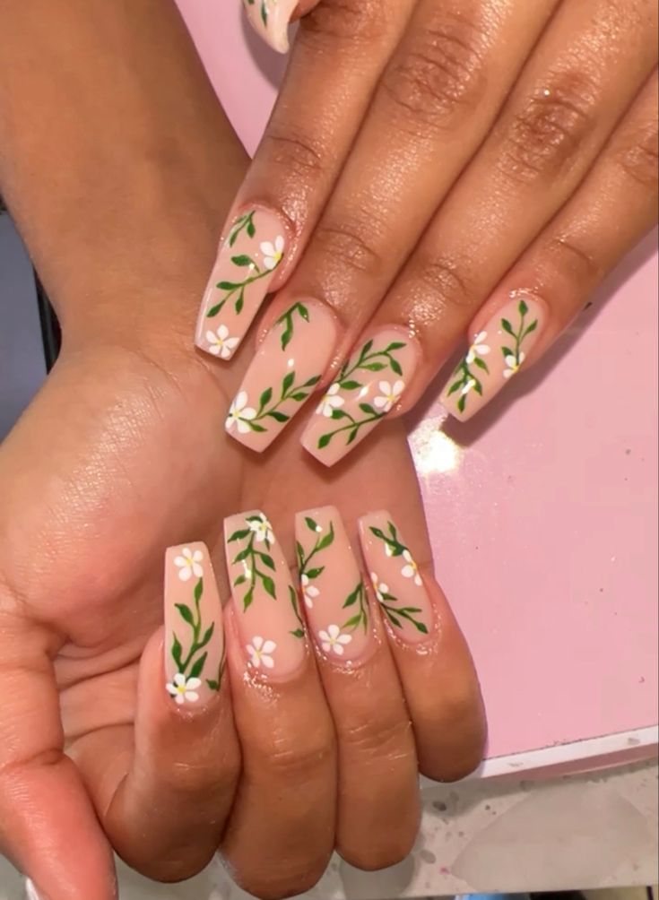 Elegant Floral Nail Design with Nude Base and Green Vines.