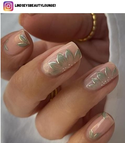 Elegant Floral Nail Design with Minimalist Green Leaves and White Accents on a Nude Base.