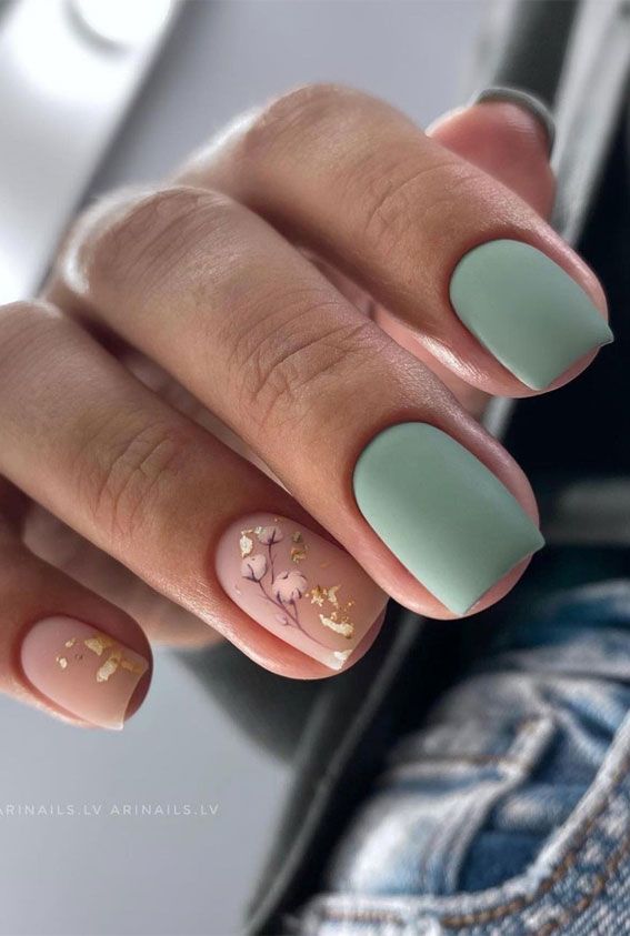 Sophisticated Pastel Nail Design with Intricate Floral Details and Gold Accents.