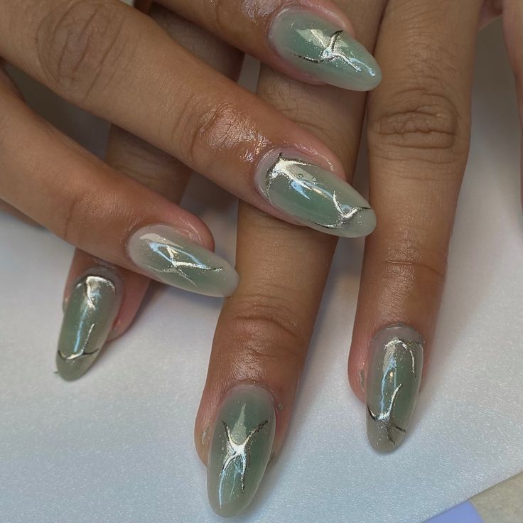 Elegant Almond-Shaped Glossy Green Nails with Shimmering Silver Accents for a Trendy Look.