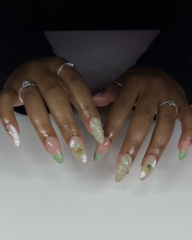 Elegant Nail Design: Pale Pink, Soft Green, and White with Geometric Patterns and Gold Accents