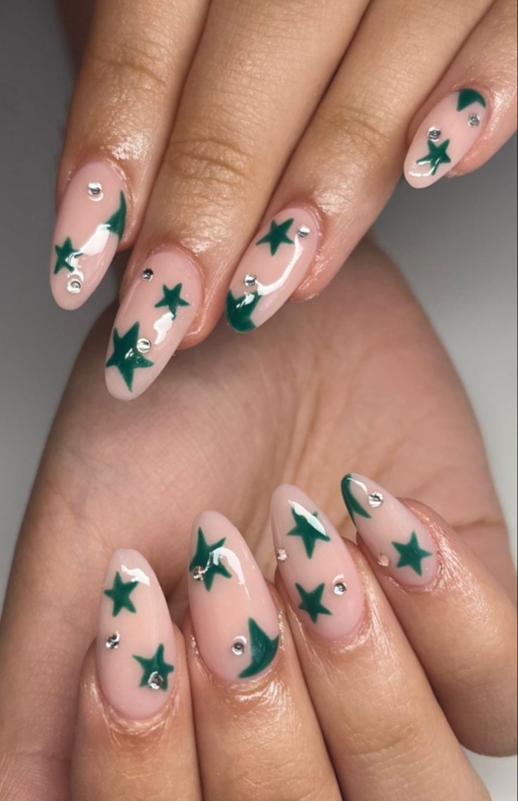 Whimsical Nude Nail Design with Vibrant Green Stars and Silver Accents