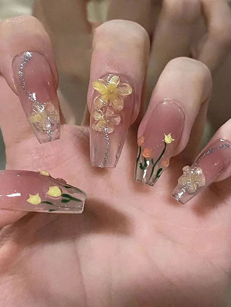 Whimsical Floral Acrylic Nails: Elegance in Soft Pink with Glittery Accents.