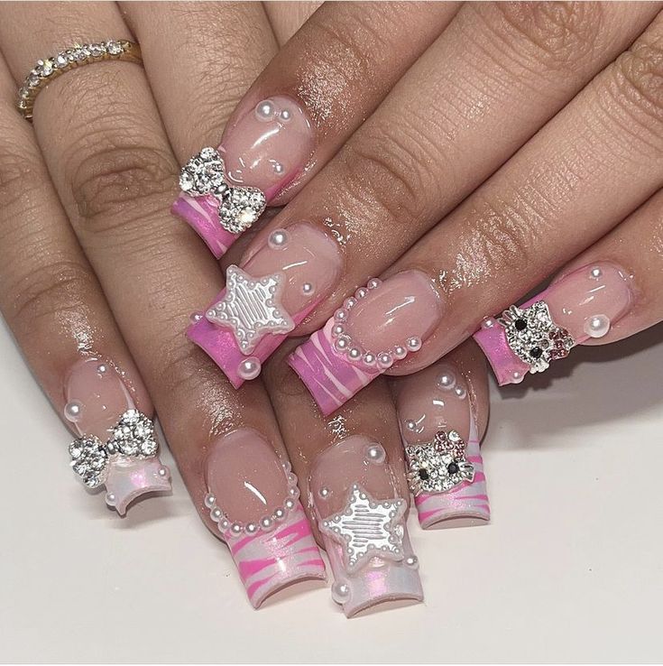 Chic Pastel Pink Acrylic Nail Design with Intricate Embellishments and Whimsical Accents