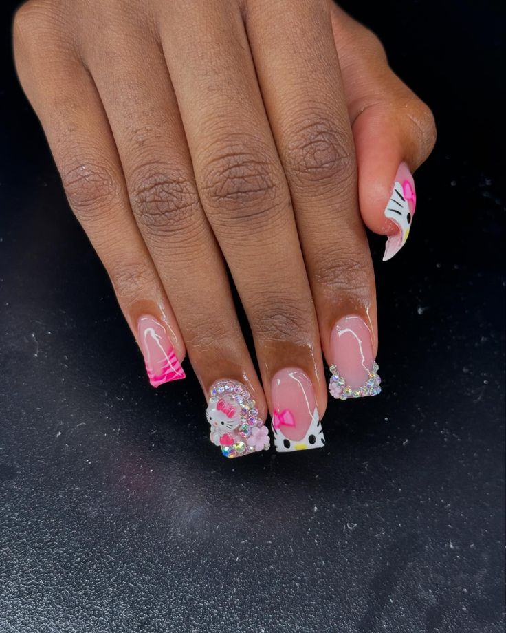 Playful and Glamorous Hello Kitty-Inspired Nail Design with Colorful Embellishments.