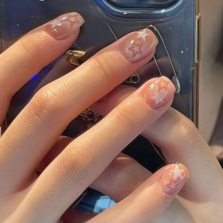 Elegant Starry Nail Design with Nude Base and White Outlines