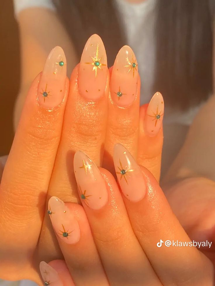 Sophisticated Ombre Nail Design with Gold Accents and Teal Gemstones