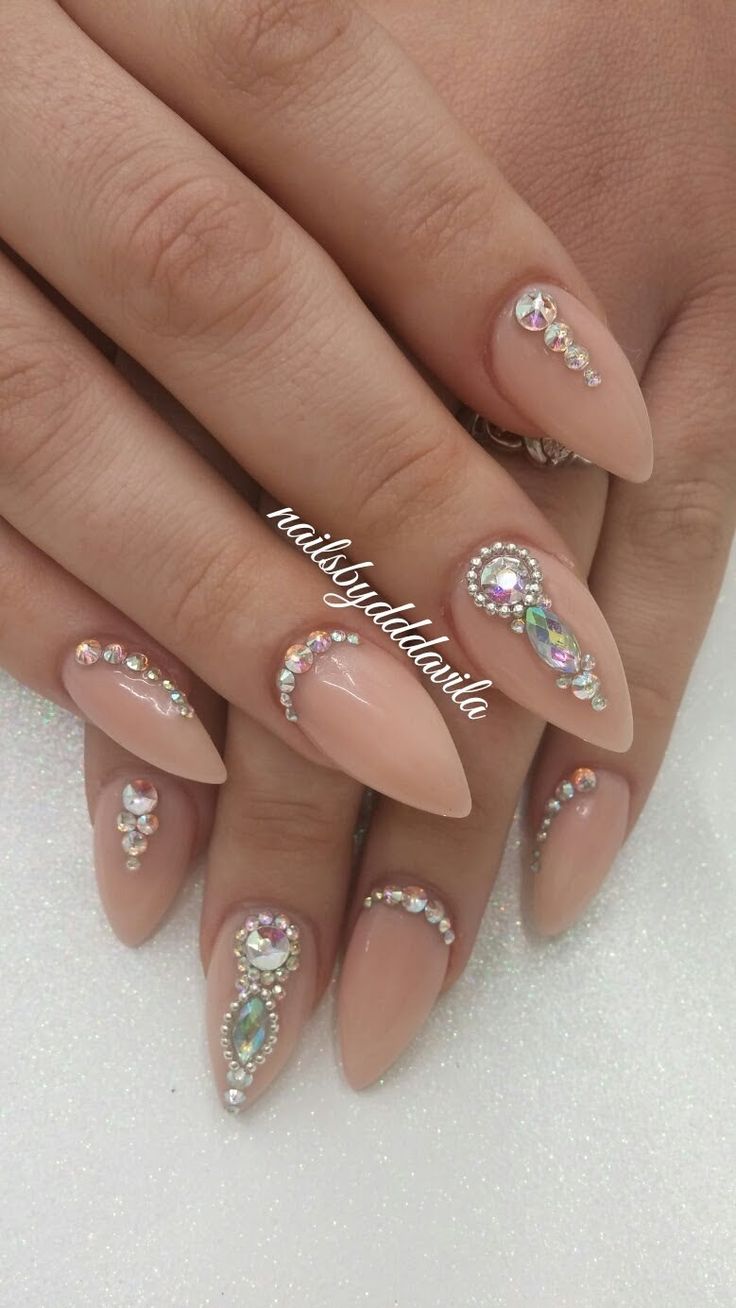 Nude Almond-Shaped Nails Adorned with Sparkling Rhinestones for a Glamorous Look.