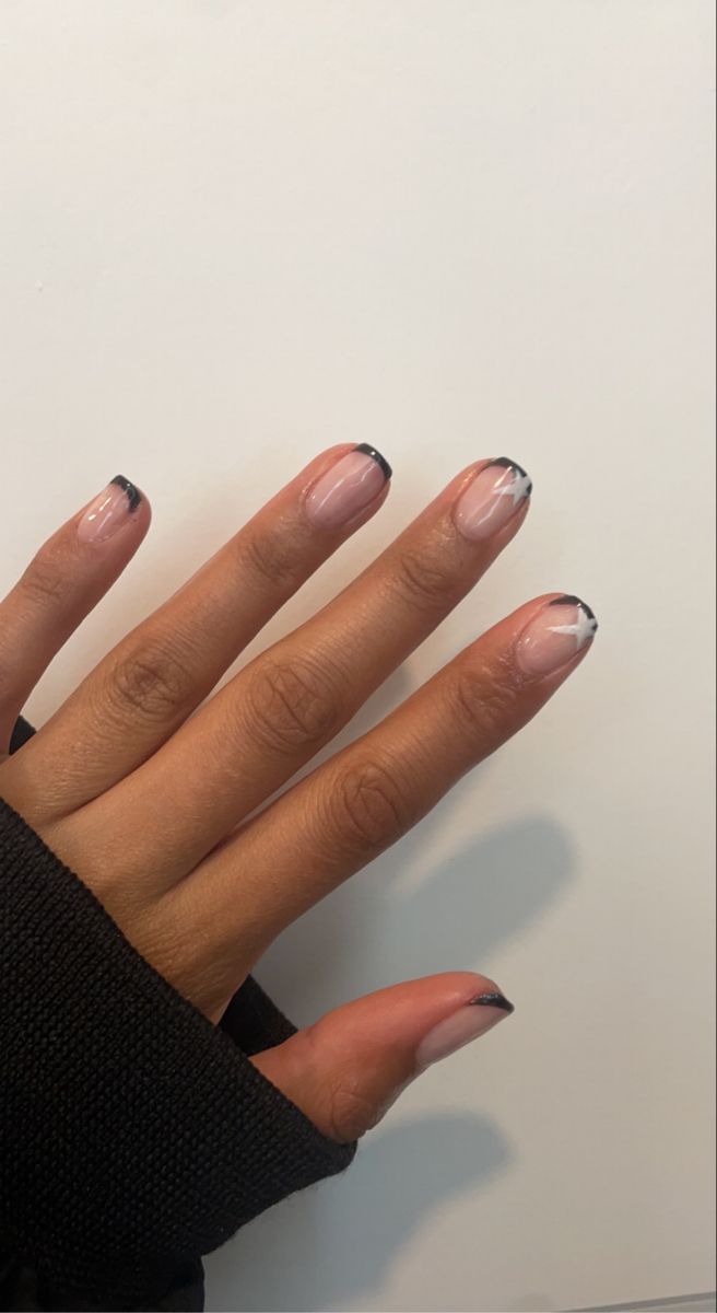 Chic Nude and Black Tip Nail Design with Geometric Accents: A Modern Minimalist Look for Any Occasion.