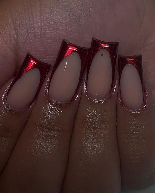 Eye-Catching Nail Design: Glossy Red Tips with Nude Base and Modern Cut-Outs.