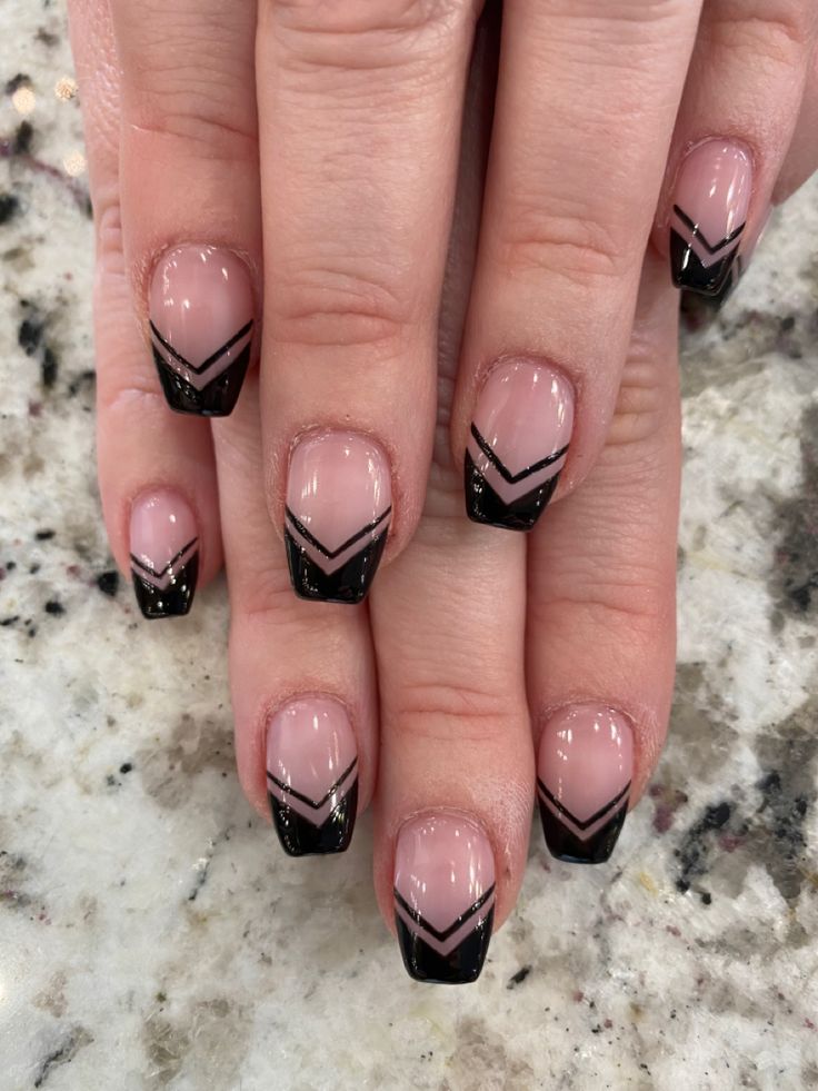 Chic Nude and Black Chevron Nail Design with Glitter Accents.