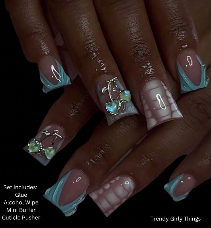 Chic Pastel Nail Design with Intricate Embellishments and Playful Patterns.