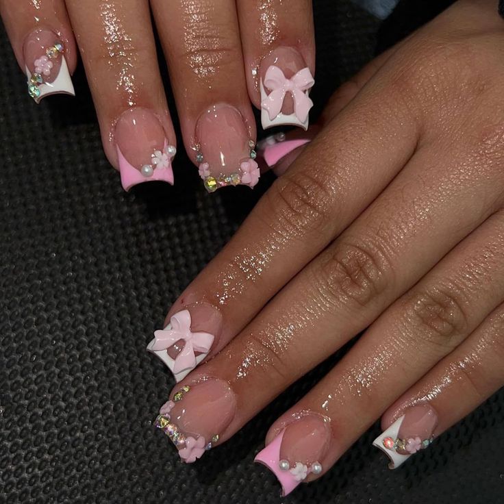 Charming Pink and White Nail Design with Bows and Gems