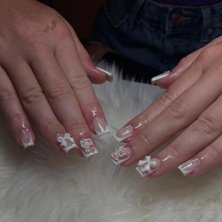 Chic Nail Design: Classic White and Soft Pink with Floral Embellishments and Glossy Finish.