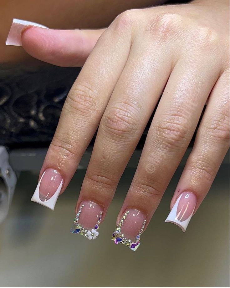 Chic French Manicure with Elegant Shaped Tips and Sparkling Rhinestone Accents.