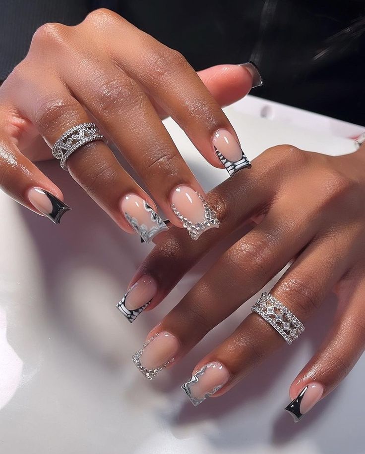 Luxurious Elegant Nail Design: Nude and Black Accents with Silver Embellishments