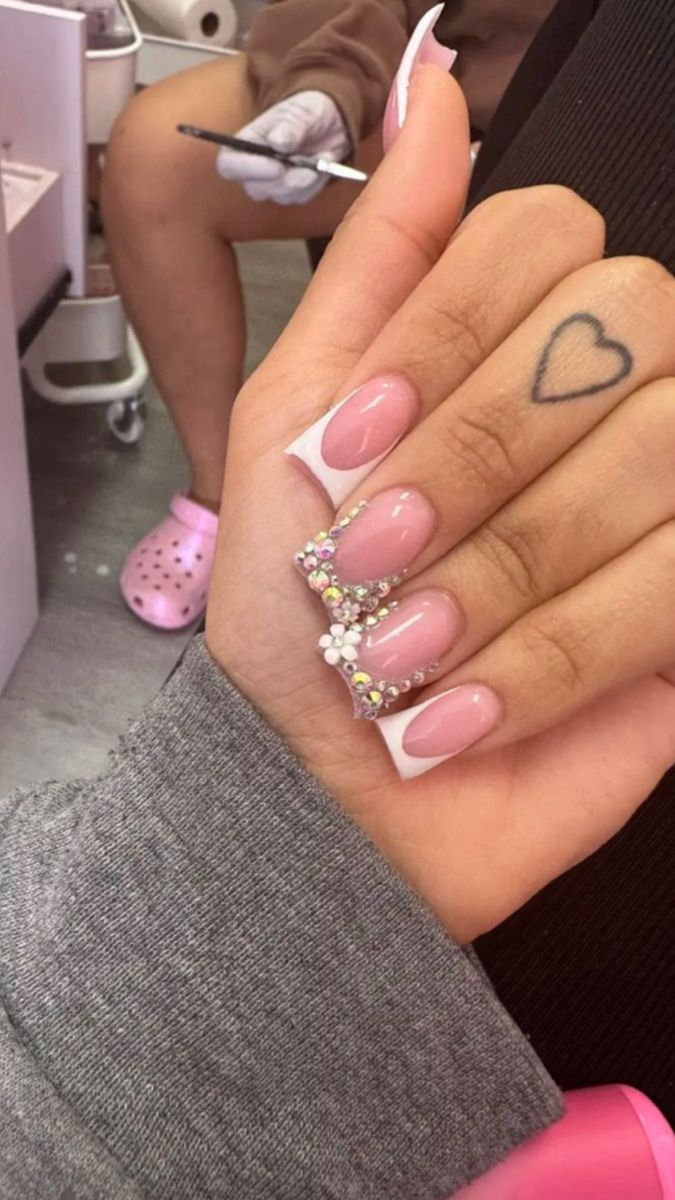 Elegant French Manicure with Colorful Gem Accents: A Sophisticated Glamour for Any Occasion.