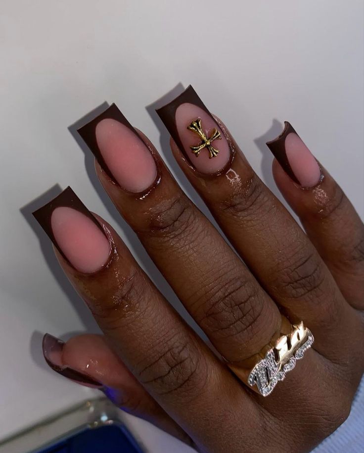 Stylish Nude and Chocolate Brown Nail Design with Oval Negative Space and Gold Accent.