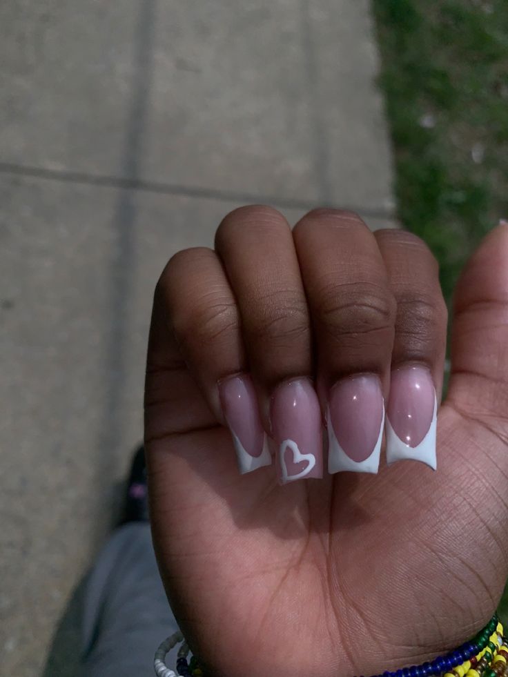 Elegant Soft Pink Nails with White Tips and Playful Heart Accent