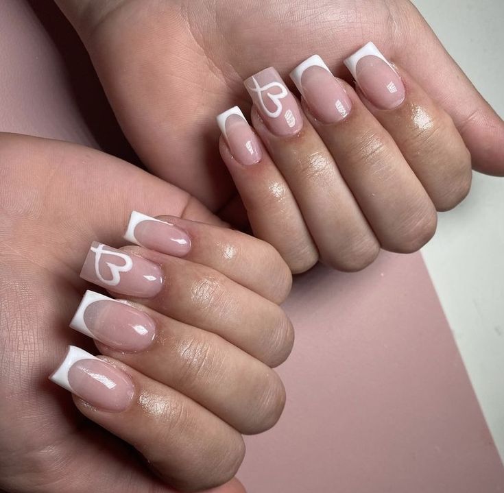 Chic French Tip Ombre Nail Design with Whimsical Heart Motifs.