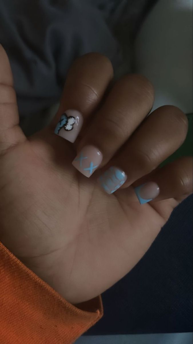 Charming Nail Design with Cloud Illustrations and Playful Patterns in Beige and Sky Blue.